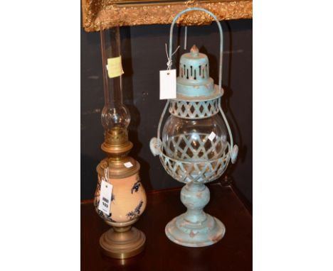A French oil lamp, with glass funnel above foliate decorated ceramic reservoir, ending in circular foot, 53cm high, together 