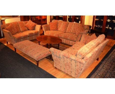 A modern upholstered lounge suite, comprising of three graduated two seater settees and a long pouffe stool, upholstered in s