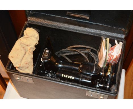A vintage portable singer sewing machine, with accessories, in fitted carry case CONDITION REPORT: Lot 185 - overall good con