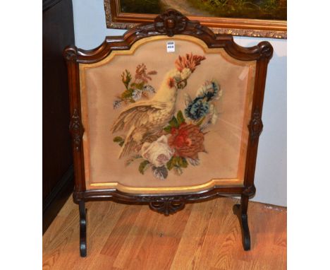 A Victorian mahogany firescreen, with embroidered panel depicting bird in foliage, 85cm high x 63cm wide CONDITION REPORT: Lo