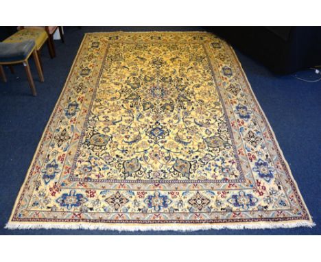 A fine Nain carpet, the central medallion with allover floral design ove cream ground with floral border, 307 x 200cm CONDITI