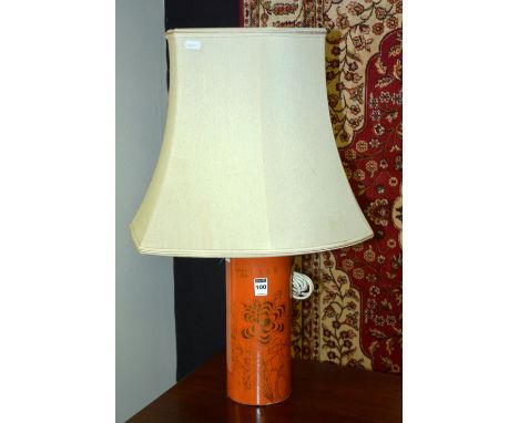 A Chinese glazed pottery table lamp, converted, with gilded foliate decoration on an orange ground, with six orange character