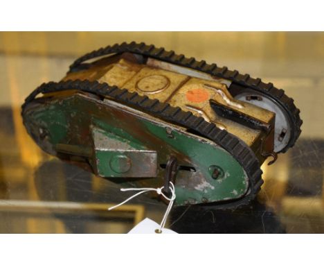 A vintage USA patent tin plate clockwork model of a tank, by Louis Mary & Co, patent no.1934589, 24cm long