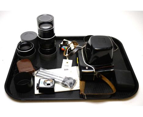 A Vintage Praktica camera; an Enna 240mm lens; and other items on a tray.