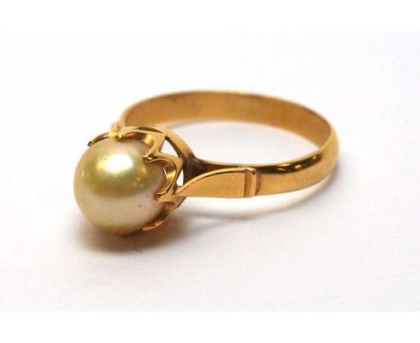 A cultured pearl ring, in crown mount, the yellow metal shank stamped '750', ring size O, 3.3g gross.