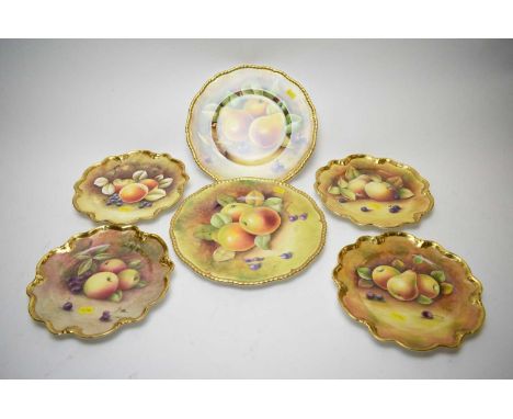 Two Coalport circular fruit plates, handpainted with fruit within a gilt border, signed by K. Davenport and R. Dale, each 27c