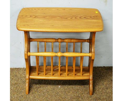 An Ercol elm side table, the moulded rectangular top above pierced trestle supports, untied by an under-tier with stick suppo