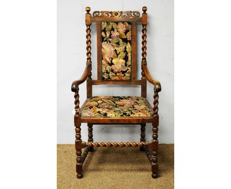 A late Victorian 17th Century style high backed armchair, the top rail with pierced and foliate scroll decoration above a rec