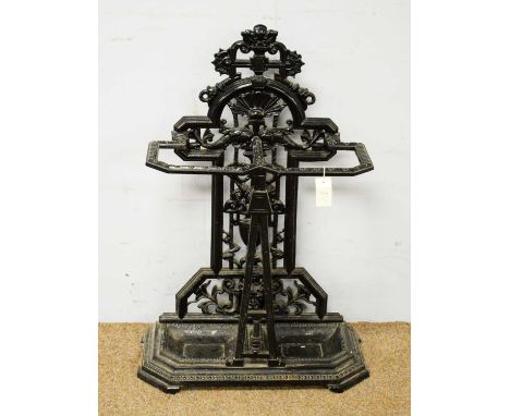 A 20th Century cast iron black painted stick stand, in the style of Coalbrookdale, with pierced back decorated with dolphins 