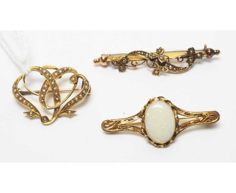 A seed pearl set Edwardian brooch of twisted design; a white opal brooch on 9ct. gold mount; and a seed pearl set brooch, mou