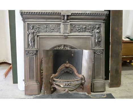 A 20th Century polished steel fire surround and fire grate, the castellated cornice above fluted pilasters surmounted by clas