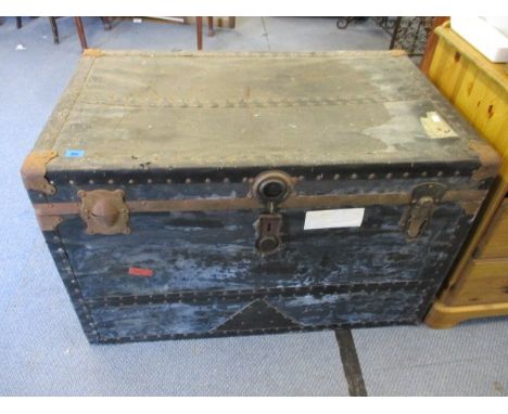 An Edwardian metal bound travel trunk with leather carrying  handles, 23 x 26