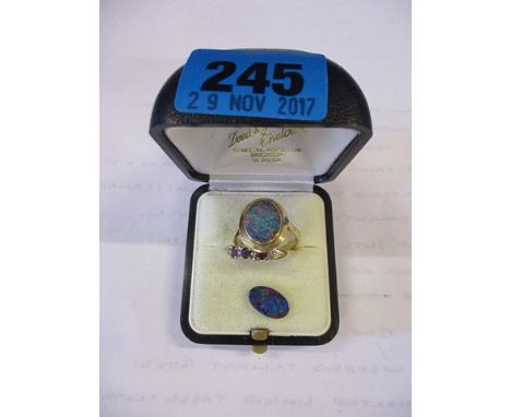 An opal ring, a loose opal stone, together with a 9ct gold ring set with three rubies and four white stones