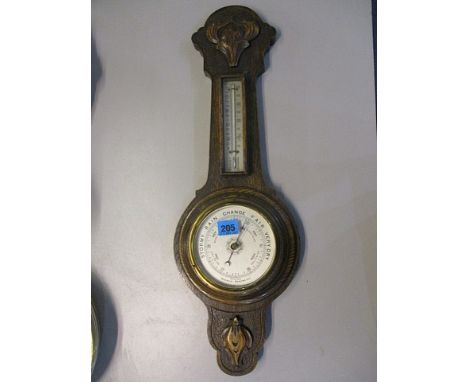 An early 20th century oak aneroid barometer, 24 1/2h