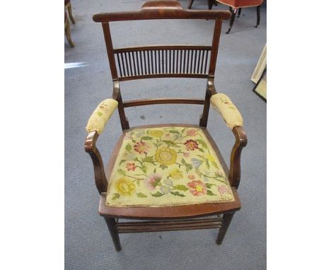 An Edwardian mahogany inlaid armchair having a tapestry seat