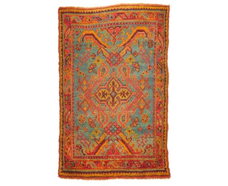 USHAK RUG WEST ANATOLIA, LATE 19TH CENTURY the light blue field with cruciform red and orange medallion, within narrow red bo