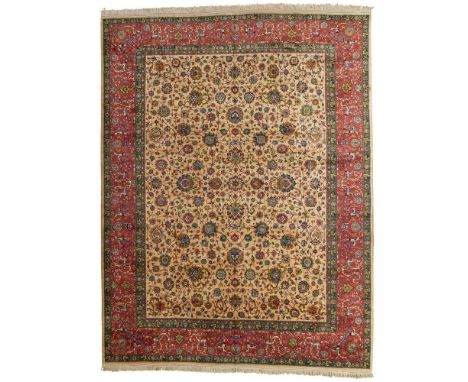 TABRIZ CARPET NORTHWEST PERSIA, MID/LATE 20TH CENTURY the light brown field with allover palmette and vine pattern, within re