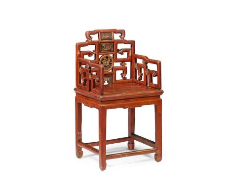 CHINESE RED STAINED AND GILT ARMCHAIR 19TH CENTURY the scroll fretwork back with ebonised and gilt panels and a relief carved
