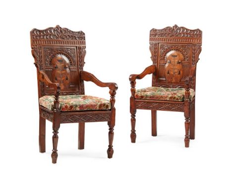 PAIR OF OAK AND MARQUETRY WAINSCOT ARMCHAIRS 19TH CENTURY the arched panel backs carved with foliate scrolls and a central ar