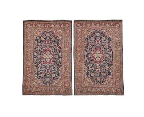 PAIR OF KASHAN RUGS CENTRAL PERSIA, LATE 19TH/EARLY 20TH CENTURY each with indigo field with red and light blue medallion, li