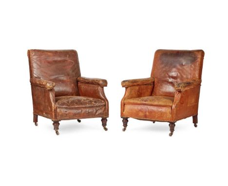 PAIR OF LATE VICTORIAN LEATHER LIBRARY ARMCHAIRS LATE 19TH CENTURY the padded square backs above deep stuffover seats flanked