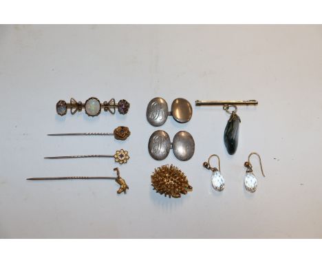 A yellow metal three stone opal set brooch, approx. 4.8gms, 4.5cm; three various yellow metal and gold mounted stick pins; a 