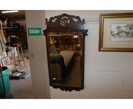 A mahogany carved wall mirror in a Chippendale style with gilt Ho Ho bird decoration