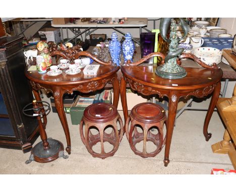 A pair of mahogany console tables raised on carved cabriole supports