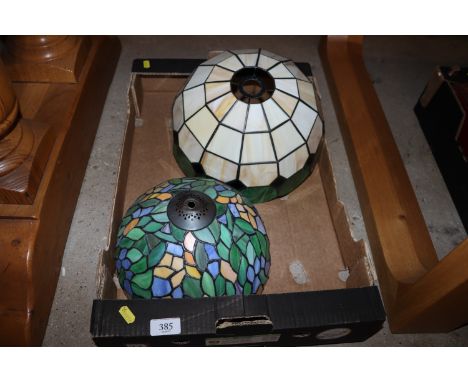 A box containing two Tiffany style light shades