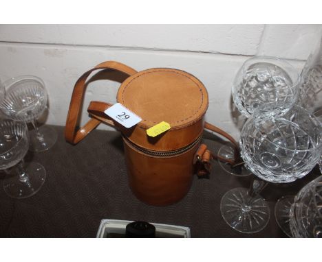 A leather cased plated travelling drinks flask in three sections complete with four cups