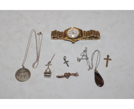 A 9ct gold brooch; a tigers eye pendant on chain, crucifix pendants ; a charm in the form of a garden roller and a ladies wri