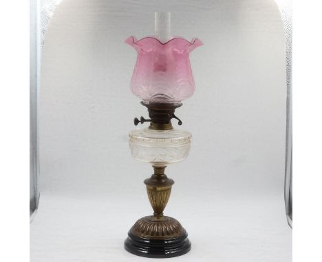 Oil lamp with glass and brass compartments, rose glass shade, H: 66 cm. Not available for in-house P&amp;P