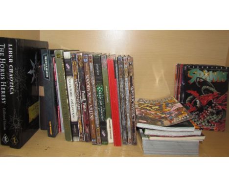Dungeons and Dragons Monster Manual together with War Hammer books, Spawn etc