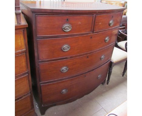 A 19th century bow fronted chest, with two short and three long graduated drawers on splayed bracket feet