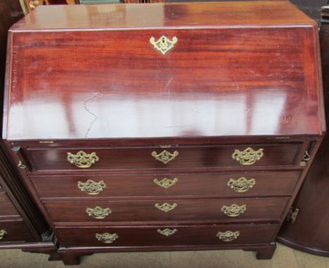 A George III mahogany bureau, the sloping fall enclosing a fitted interior, above four long graduated drawers on bracket feet