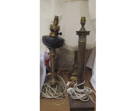 A marbled glass oil lamp on a brass column converted to electricity together with assorted brass table lamps