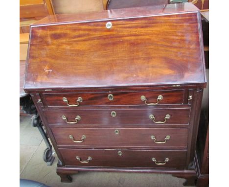A George III mahogany bureau, the sloping fall enclosing a fitted interior decorated with shell inlay, the four long graduate