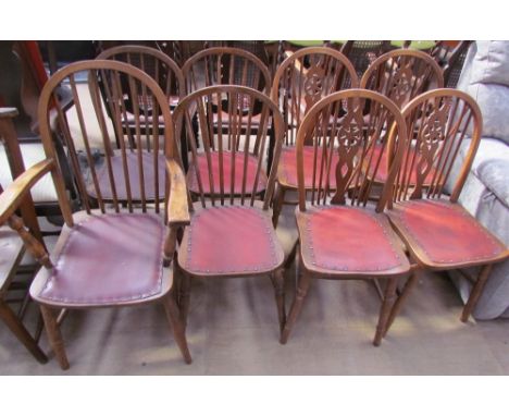 A set of four stick back dining chairs (includes a carver) together with a set of four wheel back dining chairs