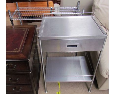 A stainless steel kitchen side table with a drawer and shelf together with a stainless steel wirework rack