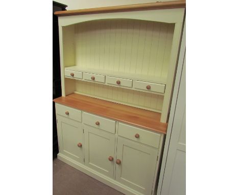 A cream painted pine kitchen dresser with a moulded cornice above a shelf with three drawers, the base with three drawers and