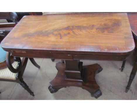 A William IV mahogany card table, the crossbanded top enclosing a felt lined interior on a square tapering column and quatref