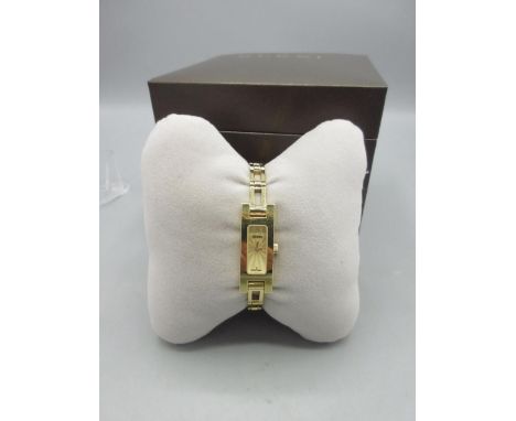 Gucci ladies gold plated quartz wristwatch on matching bracelet, gold tone engine turned dial, signed snap on case back ref. 