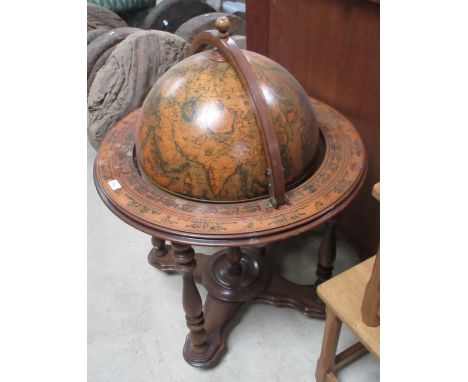 Reproduction globe drinks cabinet with hinged lift up top revealing fitted interior on turned supports
