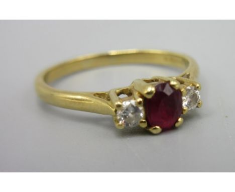 18ct yellow gold ring set with central ruby flanked by diamonds, stamped 750, size M, 2.45g
