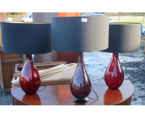 Pair of red glass bottle shaped table lamps and a similar purple lamp, all with black shades, H74cm max (3)