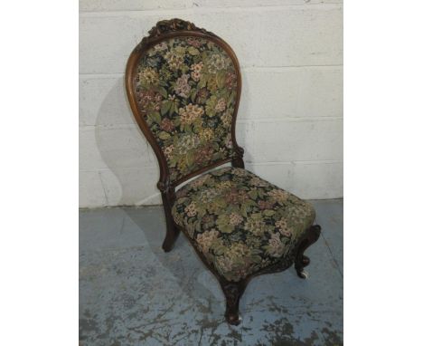 Victorian carved walnut framed nursing chair, on cabriole legs with ceramic casters, H90cm