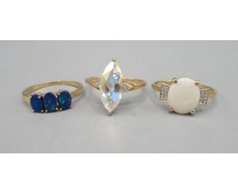 10ct yellow gold ring set with large marquise cut clear stone, size U, and two more 10ct yellow gold rings, one set with blue