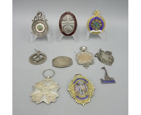 Collection of Sterling silver badges and fobs including two gilded and enamel fobs, a North Derbyshire School of Midwifery ba