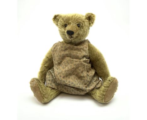 Early 20th century German Steiff teddy bear c1910 with wood wool filled humped back mohair body, swivel jointed head with bla