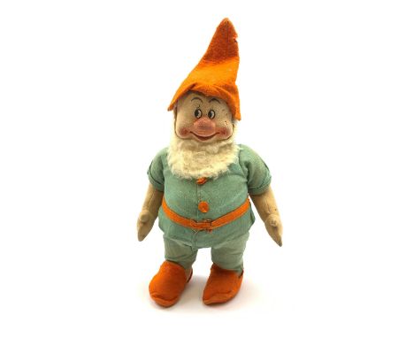 Chad Valley pressed felt figure of the Disney Snow White dwarf 'Doc' with painted facial features, standing wearing a green l